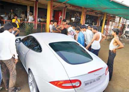 Bedazzled by the jag: People gather around the XKR to ogle the luxury vehicle Bedazzled by the jag: People gather around the XKR to ogle the luxury vehicle